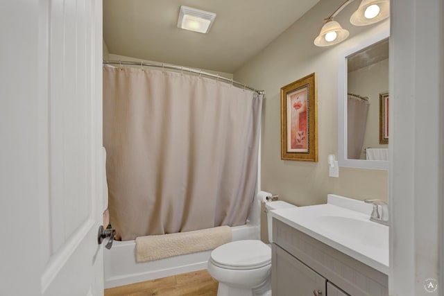 bathroom with vanity, toilet, shower / bath combination with curtain, wood finished floors, and visible vents