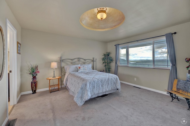 carpeted bedroom with baseboards and visible vents