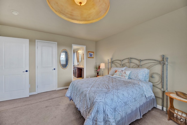 bedroom featuring baseboards, carpet, and ensuite bath