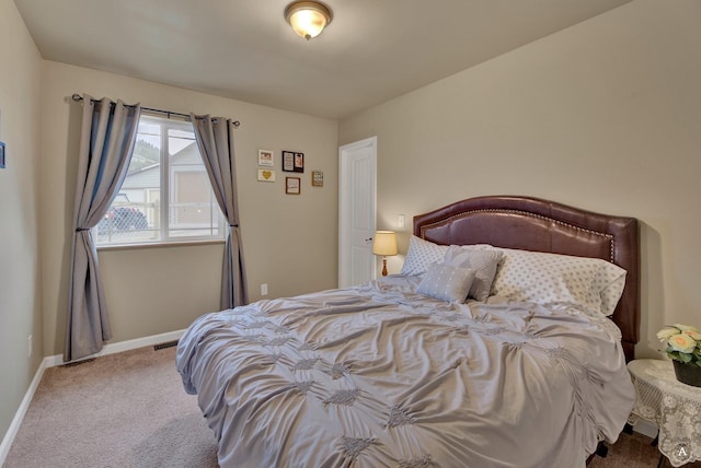 bedroom with carpet floors and baseboards