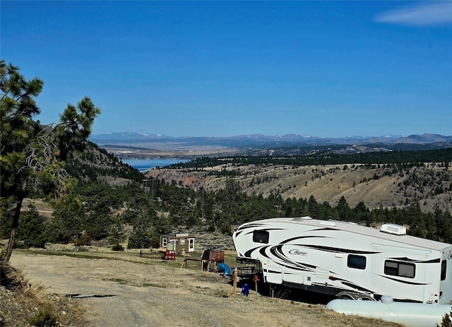 exterior space with a water and mountain view