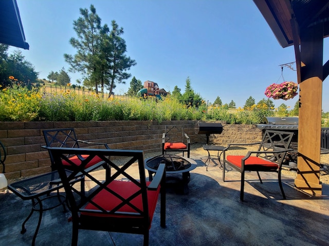 view of patio with a fire pit and area for grilling