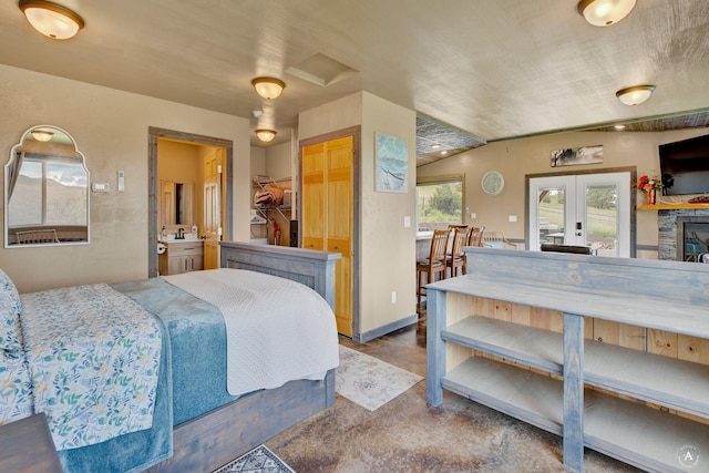 bedroom featuring finished concrete floors and french doors