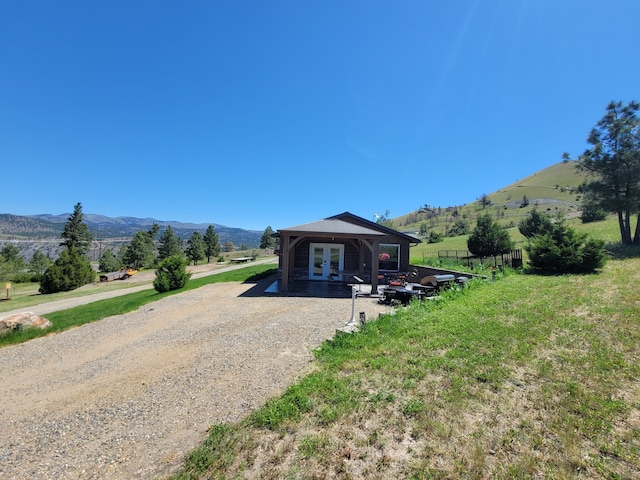 exterior space with french doors and a mountain view