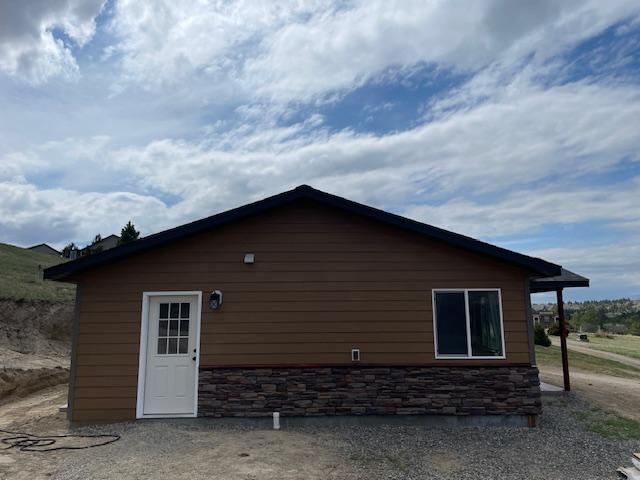 view of property exterior with stone siding