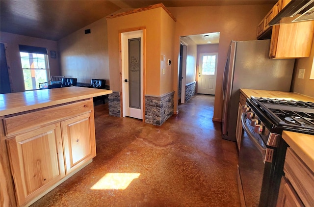 kitchen featuring stainless steel gas range, butcher block countertops, lofted ceiling, finished concrete floors, and under cabinet range hood