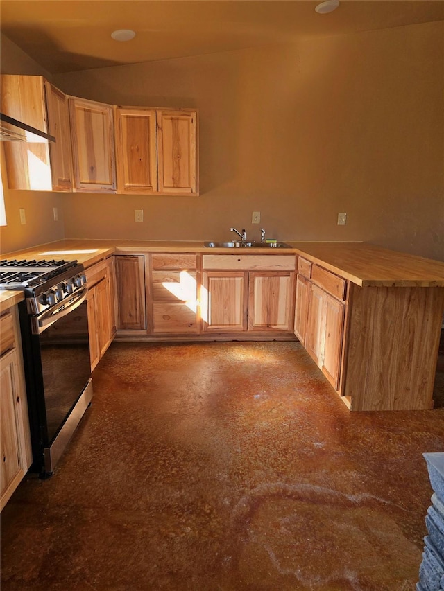 kitchen featuring a sink, light brown cabinets, light countertops, finished concrete flooring, and range with gas cooktop