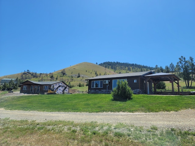 view of front of home featuring a gazebo, a mountain view, and a front yard