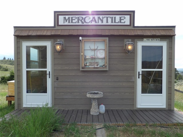 entrance to property featuring metal roof