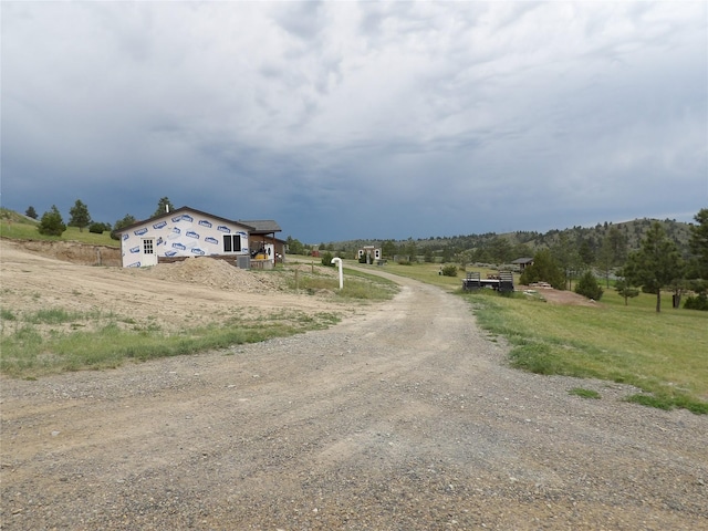 view of street featuring driveway and a rural view