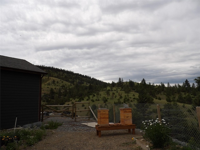 view of yard featuring a mountain view and fence