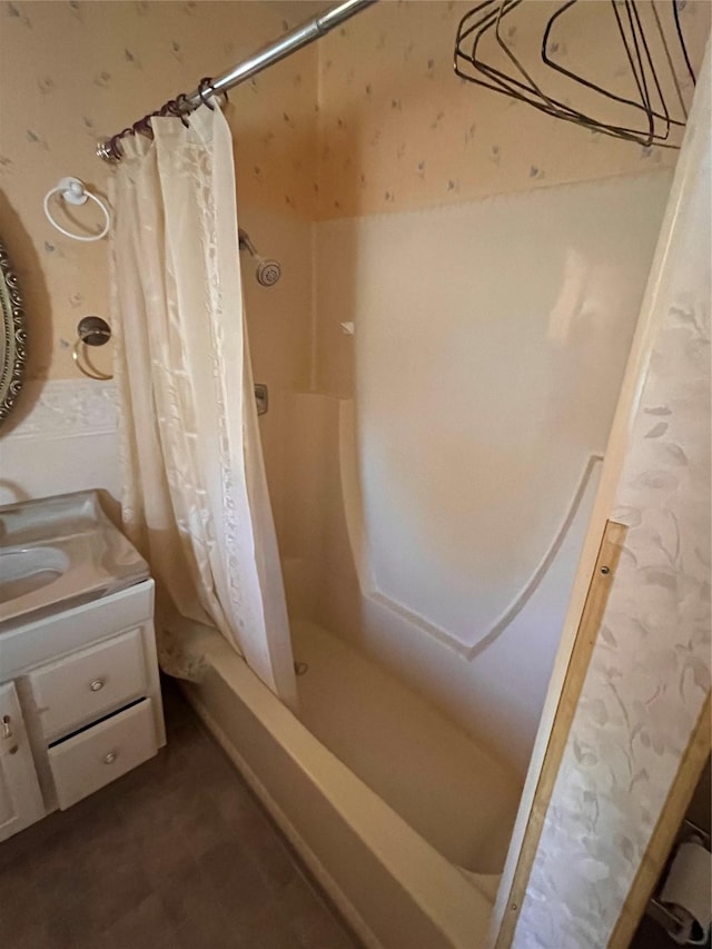 bathroom featuring vanity and shower / bathtub combination with curtain