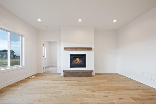 unfurnished living room featuring light hardwood / wood-style flooring