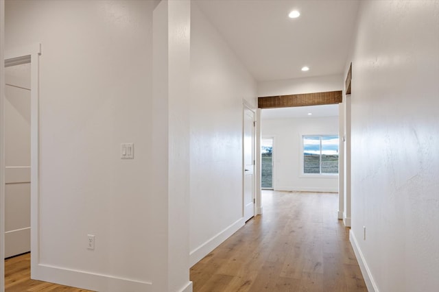 hallway with light hardwood / wood-style floors