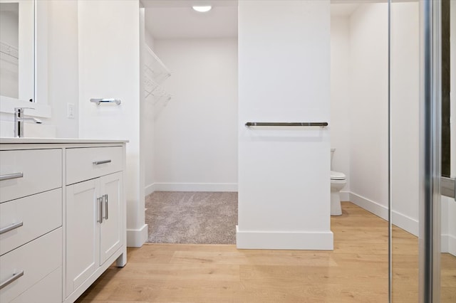 bathroom featuring hardwood / wood-style floors, vanity, and toilet