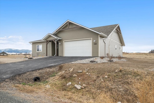 view of front of home featuring a mountain view and a garage