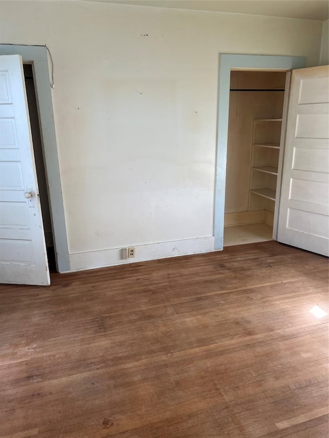 unfurnished bedroom with hardwood / wood-style flooring