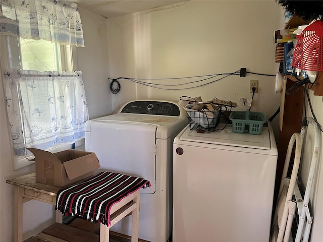 clothes washing area featuring separate washer and dryer