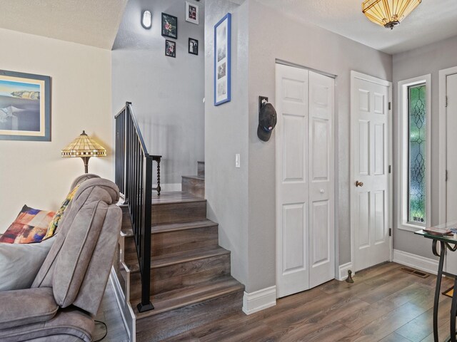 1915 E Broadway St, Missoula, MT 59802 - foyer entrance with stairs, baseboards, dark wood finished floors, and visible vents