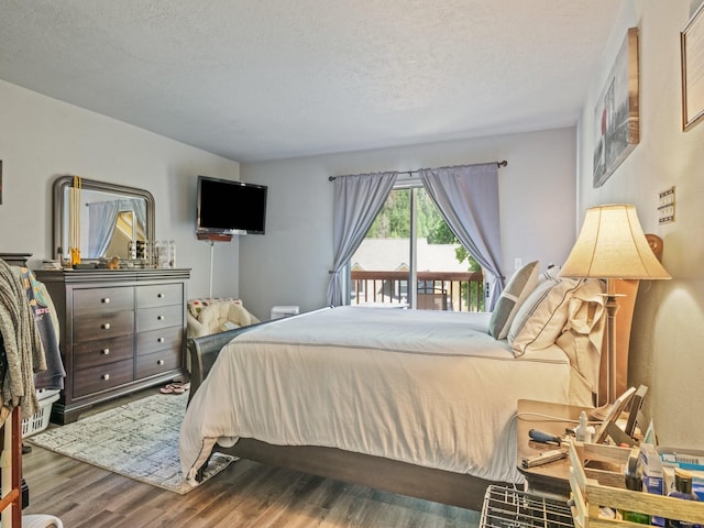 1915 E Broadway St, Missoula, MT 59802 - bedroom featuring a textured ceiling, access to exterior, and wood finished floors