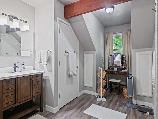 1915 E Broadway St, Missoula, MT 59802 - bathroom with baseboards, beamed ceiling, wood finished floors, and vanity