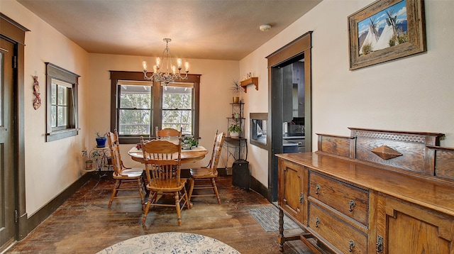 dining room featuring an inviting chandelier and dark wood-type flooring