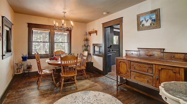 dining room featuring a notable chandelier and dark wood-type flooring