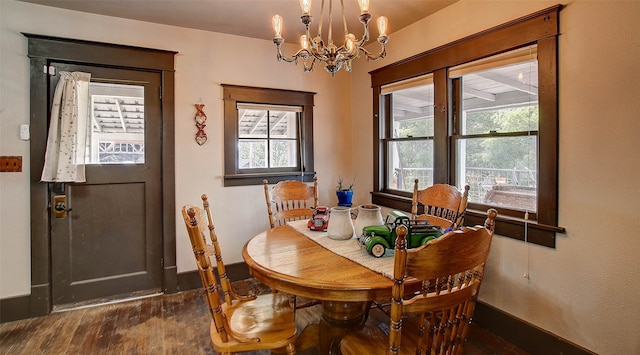 dining space featuring plenty of natural light, dark hardwood / wood-style floors, and a chandelier