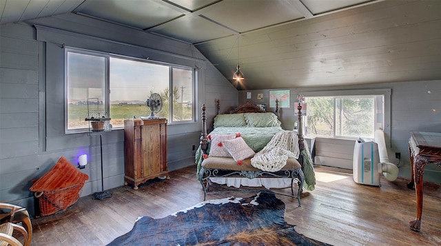 bedroom with vaulted ceiling, wood ceiling, wooden walls, and hardwood / wood-style floors