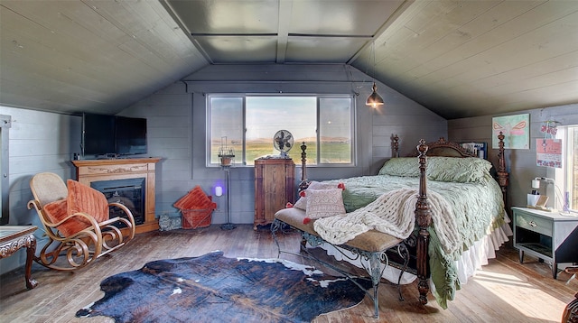 bedroom featuring lofted ceiling and hardwood / wood-style flooring