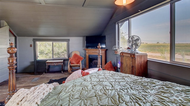 bedroom with hardwood / wood-style flooring and vaulted ceiling