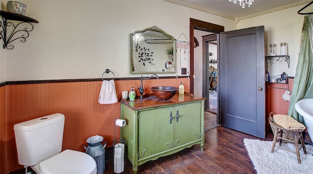 bathroom featuring sink, crown molding, wood-type flooring, and toilet