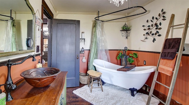 bathroom featuring sink, crown molding, and wood-type flooring