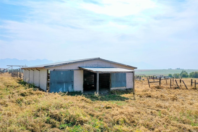 view of outbuilding with a rural view