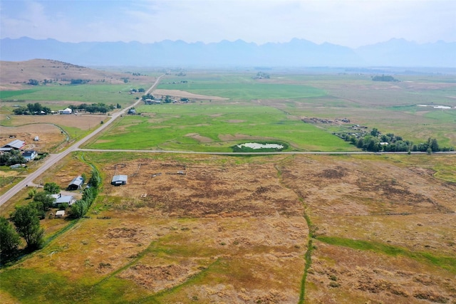 birds eye view of property with a mountain view and a rural view