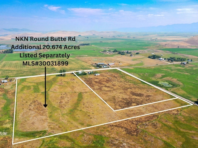 drone / aerial view featuring a mountain view and a rural view