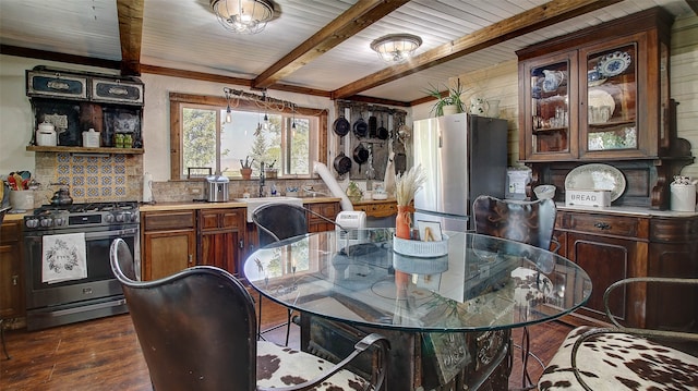 dining room with beamed ceiling and dark hardwood / wood-style floors