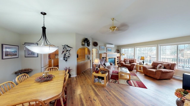 33953 Fox Rd, Polson, MT 59860 - dining area featuring ceiling fan, wood finished floors, plenty of natural light, a baseboard heating unit, and vaulted ceiling