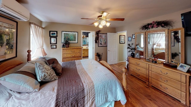 33953 Fox Rd, Polson, MT 59860 - bedroom featuring a wall unit AC, wood finished floors, ceiling fan, and ensuite bath