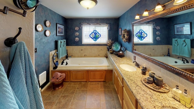 33953 Fox Rd, Polson, MT 59860 - full bath featuring a garden tub, wallpapered walls, and double vanity