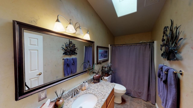 33953 Fox Rd, Polson, MT 59860 - full bathroom with vanity, a skylight, a shower with curtain, and stone finish floors