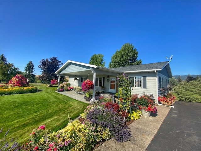 33953 Fox Rd, Polson, MT 59860 - view of front of house featuring a front yard and covered porch