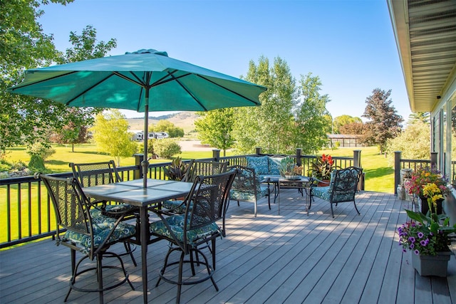 33953 Fox Rd, Polson, MT 59860 - wooden deck with outdoor dining space and a lawn