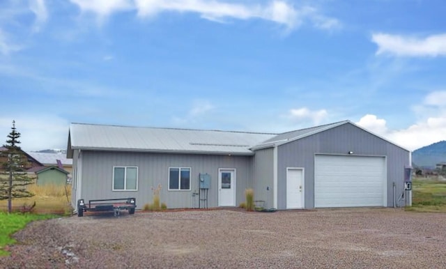 33953 Fox Rd, Polson, MT 59860 - ranch-style home with dirt driveway, a garage, and a metal roof