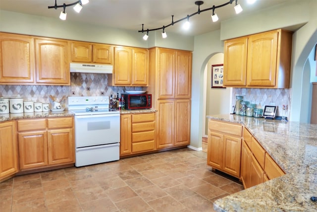 33953 Fox Rd, Polson, MT 59860 - kitchen with white electric stove, arched walkways, under cabinet range hood, and rail lighting