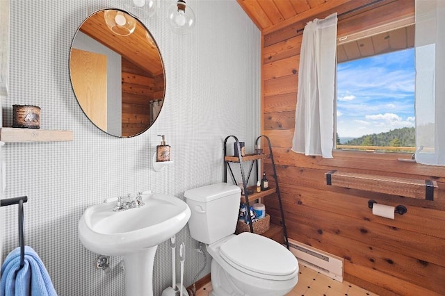 half bathroom with toilet, wooden ceiling, and a baseboard radiator