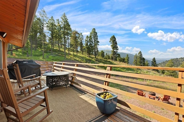 wooden terrace featuring a grill