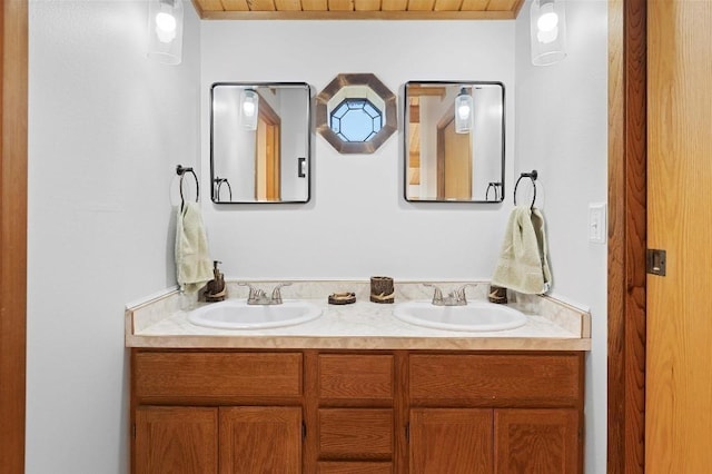 full bathroom with double vanity and a sink