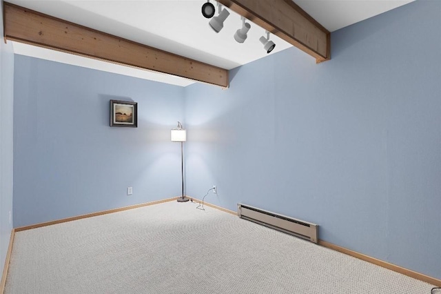 unfurnished room with a baseboard heating unit, carpet floors, beam ceiling, and baseboards