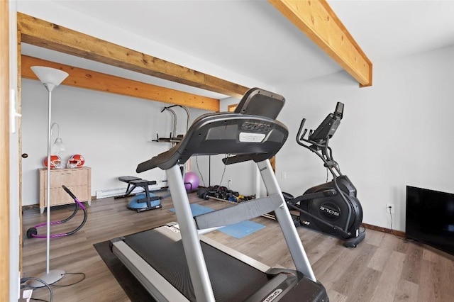 exercise area featuring light wood-type flooring and baseboards